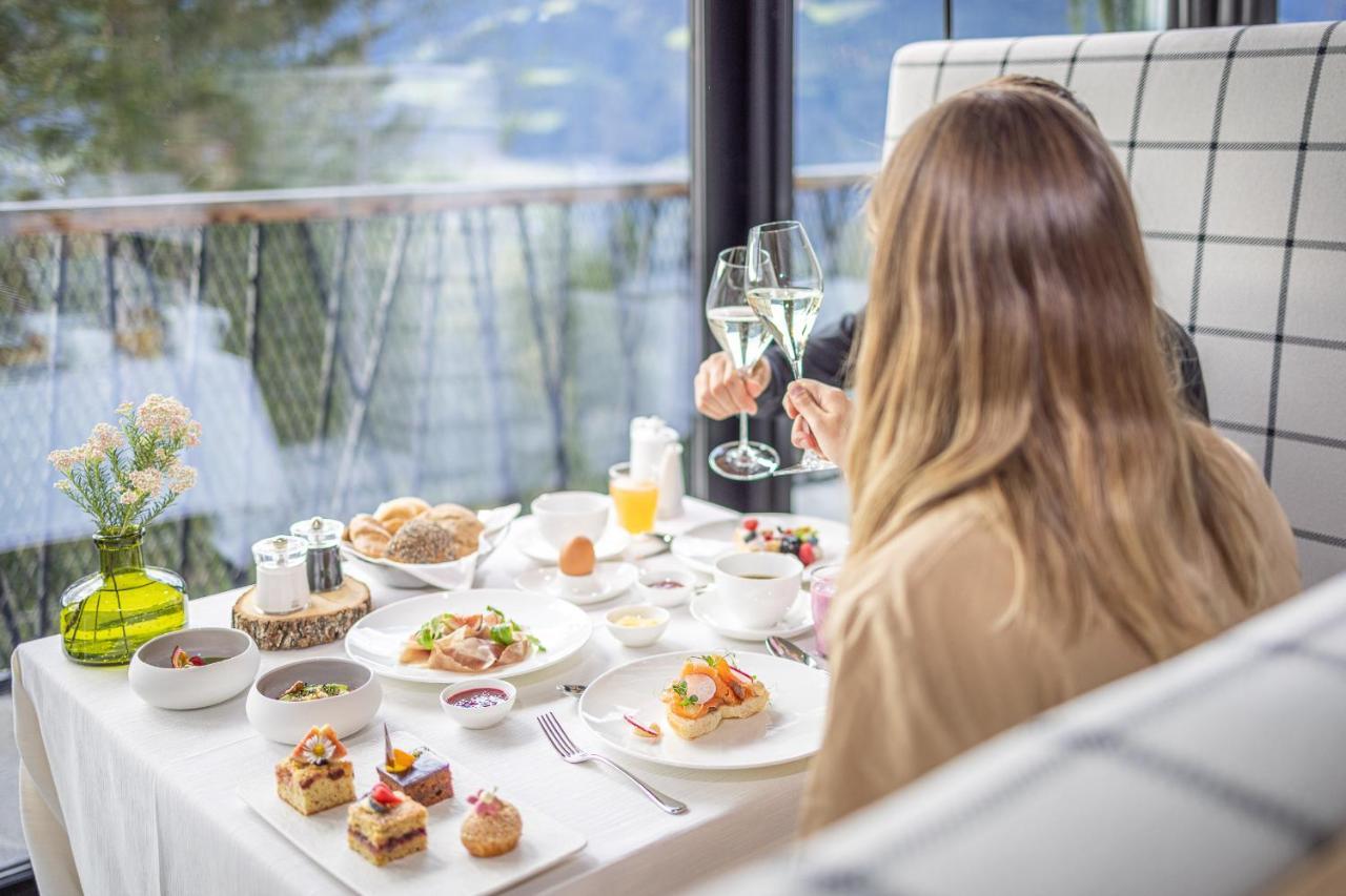 My Arbor - Dolomites Hotel Bressanone Exterior photo A woman enjoying a meal at a restaurant
